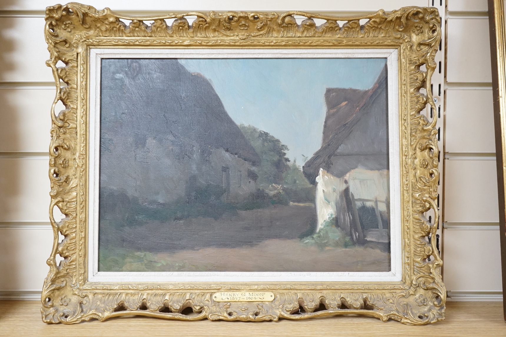 Henry G. Moon (1857-1905), oil on canvas, Village scene, signed in ink verso, inscribed plaque, 29 x 39cm, ornate gilt frame. Condition - good